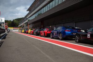 Supercars lined up at the Autopolis stand at Spa Francorchamps during the After 6 event, ready to hit the track.