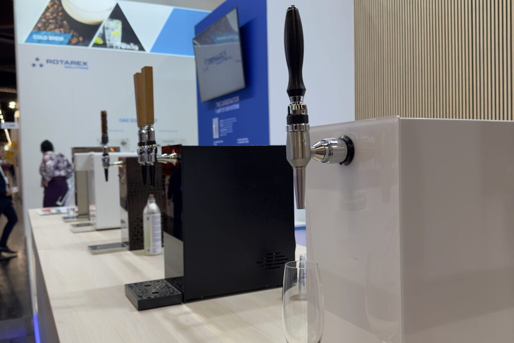 A sparkling cocktail dispensing system on display at a tradeshow, showcasing its innovative features