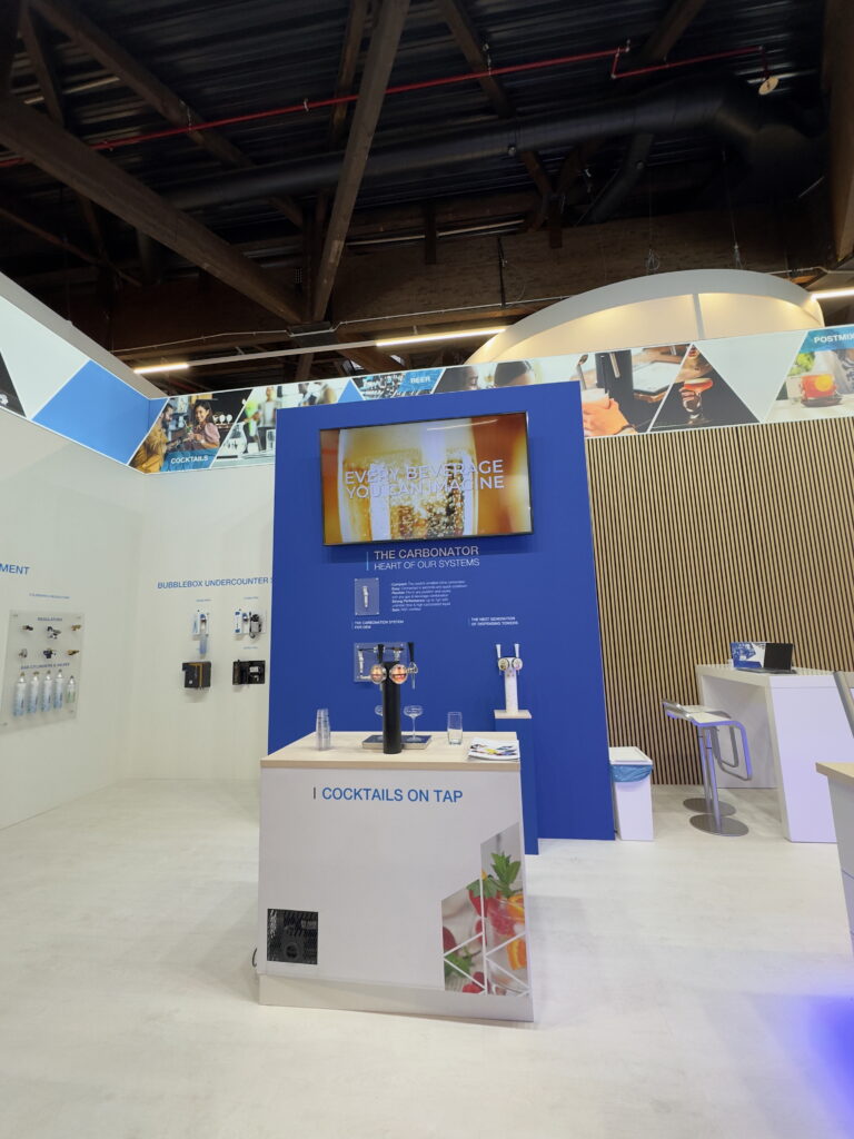 A professionally designed booth at a trade show, showcasing vibrant displays and promotional materials.